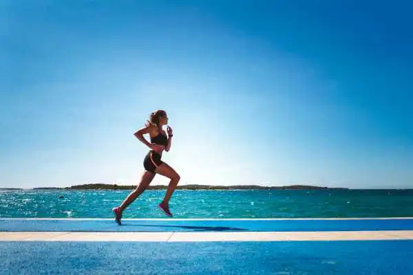 Woman running showing strong leg muscle Northfield
